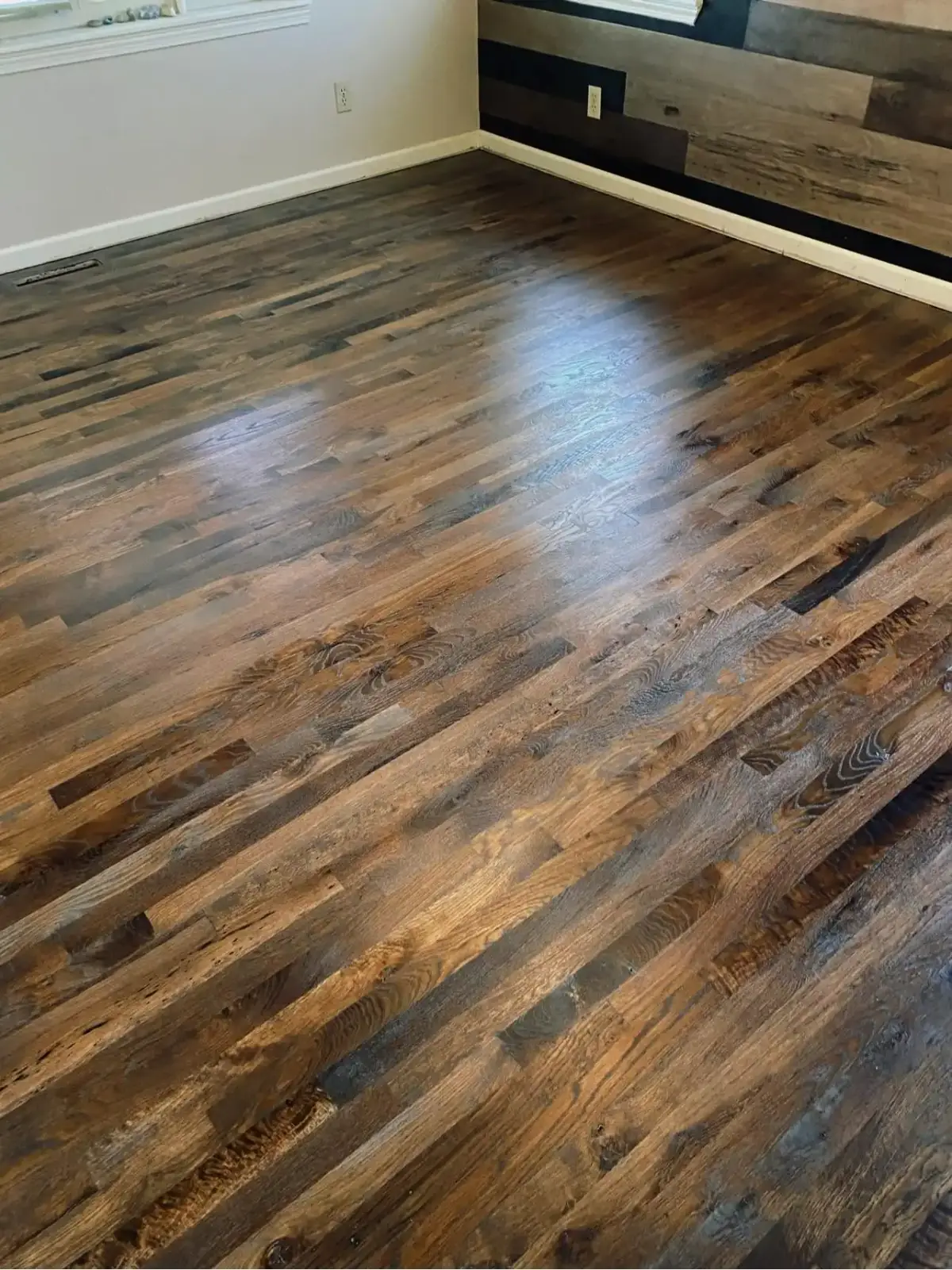 Worn hardwood floor before JRK Flooring’s work